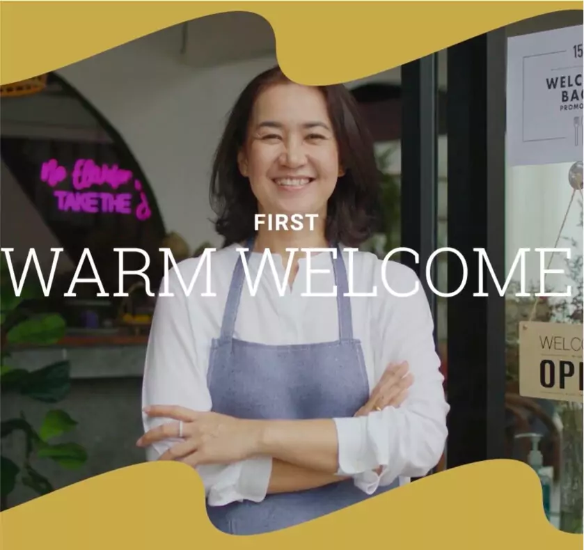 Polaroid-style image used in a travel and hospitality campaign, featuring a smiling woman outside a venue with the words “Warm Welcome.”
